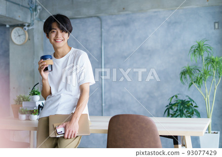 Young man studying in a cafe 93077429