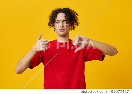 Dissatisfied funny Caucasian young man in red t-shirt show Dis Like gesture posing isolated on yellow studio background. The best offer with free place for advertising. Emotions for everyday concept Dissatisfied funny Caucasian young man in red t-shirt show Dis Like gesture posing isolated on yellow studio background. The best offer with free place for advertising. Emotions for everyday concept 93077437