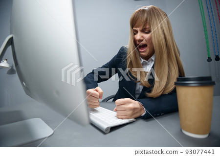 Evil irritated millennial blonde businesswoman worker in blue jacket breaks keyboard hate operation crash in gray modern office. Remote Job, Technology And Career Profession Concept. Wide angle Evil irritated millennial blonde businesswoman worker in blue jacket breaks keyboard hate operation crash in gray modern office. Remote Job, Technology And Career Profession Concept. Wide angle 93077441