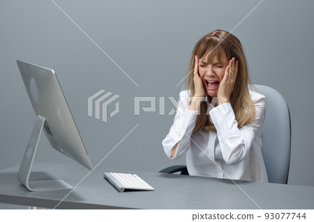 Crying pretty blonde businesswoman made critical mistake using desktop computer touch cheeks sitting in gray modern office. Remote Job, Technology And Career Profession Concept. Copy space Crying pretty blonde businesswoman made critical mistake using desktop computer touch cheeks sitting in gray modern office. Remote Job, Technology And Career Profession Concept. Copy space 93077744