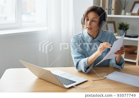 Concentrated self-confident adorable curly businesswoman leader talking with colleagues at online meeting with their purposes and questions tells about new startup idea or methods to improving work Concentrated self-confident adorable curly businesswoman leader talking with colleagues at online meeting with their purposes and questions tells about new startup idea or methods to improving work 93077749