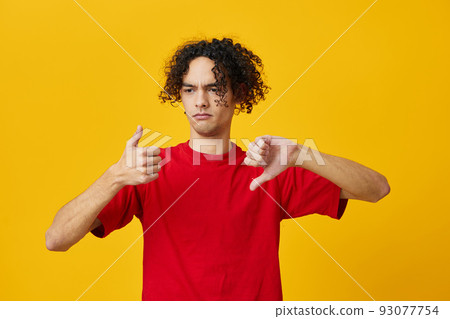 Dissatisfied funny Caucasian young man in red t-shirt show Dis Like gesture posing isolated on yellow studio background. The best offer with free place for advertising. Emotions for everyday concept Dissatisfied funny Caucasian young man in red t-shirt show Dis Like gesture posing isolated on yellow studio background. The best offer with free place for advertising. Emotions for everyday concept 93077754