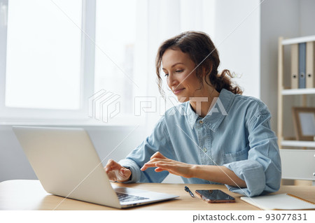 Cheerful adorable curly businesswoman worker freelancer chatting with client registers an order in social media in light office. Happy employee work on computer online in support service. Copy space Cheerful adorable curly businesswoman worker freelancer chatting with client registers an order in social media in light office. Happy employee work on computer online in support service. Copy space 93077831