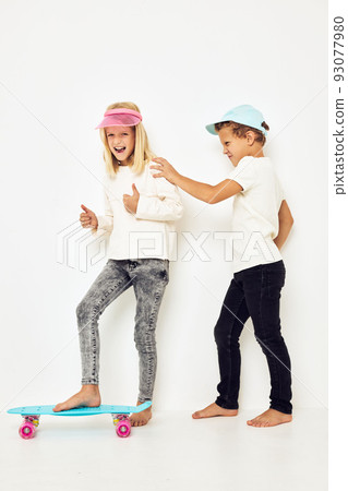 Modern teenagers posing together casual street style light background 93077980