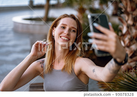 Young casual woman using her smartphone in the city. Young casual woman using her smartphone in the city. 93078328