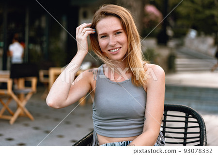 Portrait of a young beautiful woman in the summer city 93078332