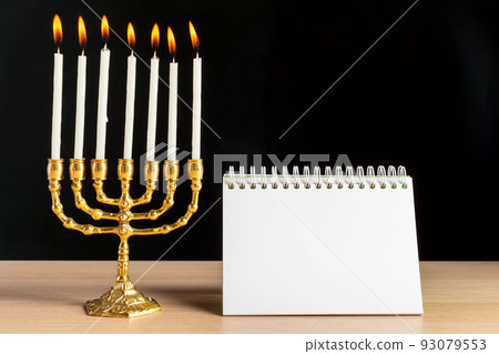 Bronze Hanukkah menorah with burning candles Bronze Hanukkah menorah with burning candles 93079553