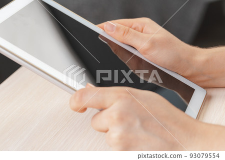 woman holding digital tablet, closeup woman holding digital tablet, closeup 93079554