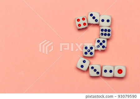 Number two lay out of dice on peachy background close up 93079590