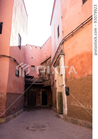 A reddish-brown building on the side of a narrow road in the medina of Marrakech, Morocco A reddish-brown building on the side of a narrow road in the medina of Marrakech, Morocco 93079923