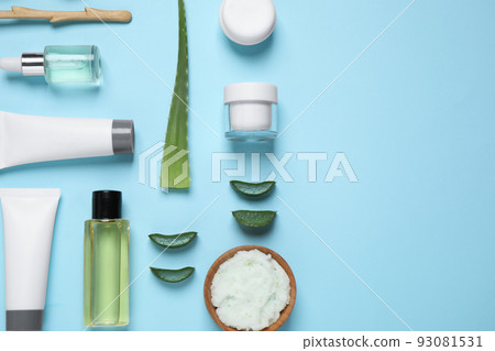 Flat lay composition with aloe vera and cosmetic products on light blue background. Space for text 93081531