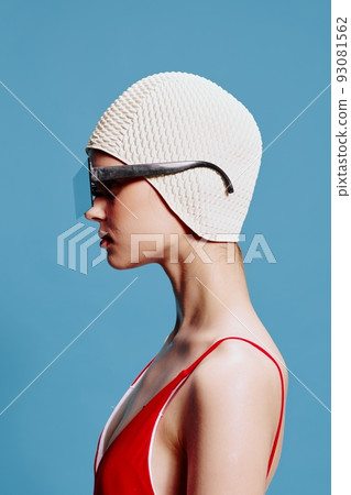Fashion woman in profile in a red swimsuit stylish glasses and a swimming cap 93081562