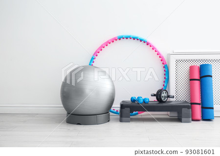Different sports equipment near white wall in gym Different sports equipment near white wall in gym 93081601