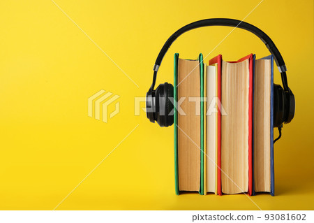 Books with modern headphones on yellow background. Space for text Books with modern headphones on yellow background. Space for text 93081602