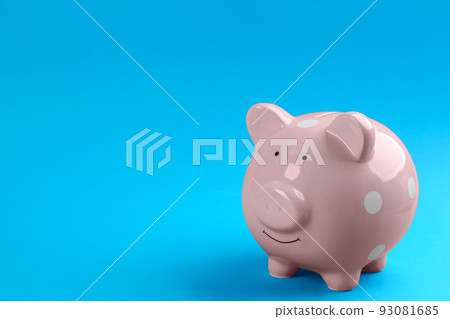 Pink piggy bank on blue background. Space for text Pink piggy bank on blue background. Space for text 93081685