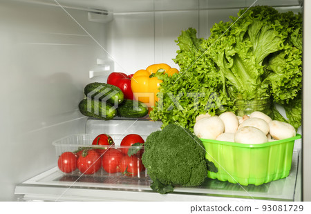 Open refrigerator full of different fresh products 93081729