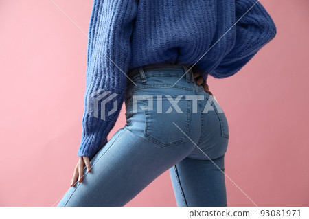 Woman wearing jeans on pink background, closeup 93081971