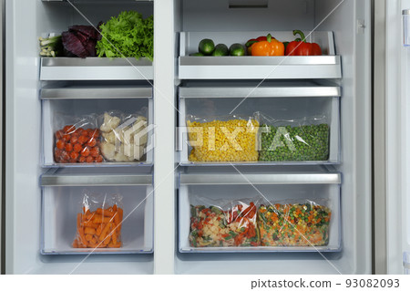 Open refrigerator with different vegetables, closeup view Open refrigerator with different vegetables, closeup view 93082093