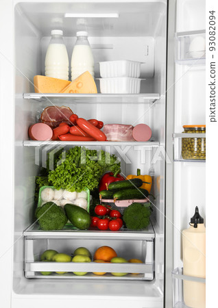 Open refrigerator full of different fresh products Open refrigerator full of different fresh products 93082094
