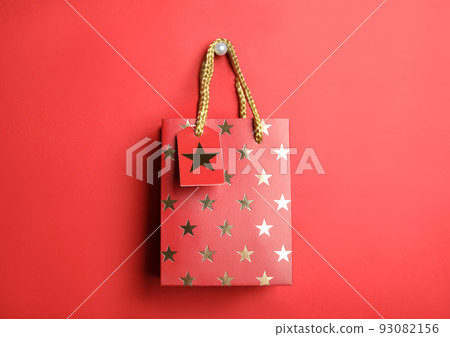 Shopping paper bag with star pattern on red background 93082156