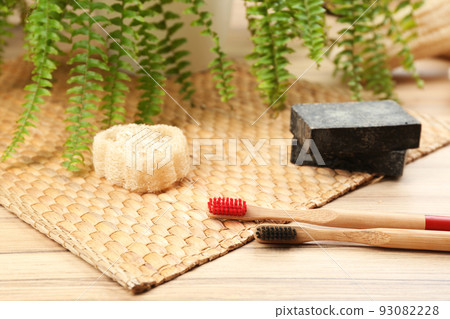 Natural toothbrushes made with bamboo on wooden table 93082228