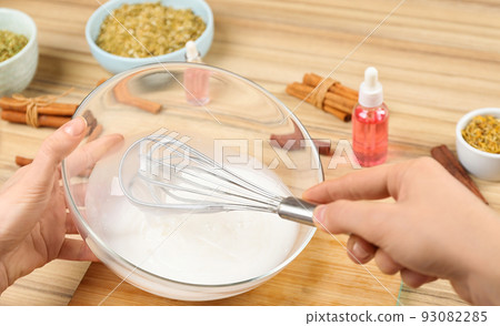 Woman making natural handmade soap at wooden table, closeup Woman making natural handmade soap at wooden table, closeup 93082285