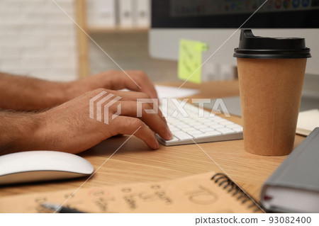 Man using computer at table in office, closeup Man using computer at table in office, closeup 93082400