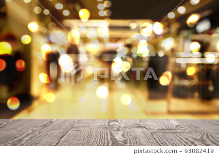 Empty wooden surface and blurred view of shopping mall. Space for design 93082419