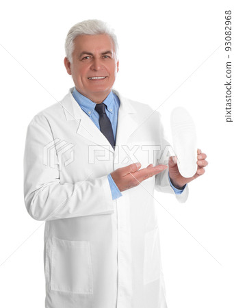 Male orthopedist showing insole on white background 93082968