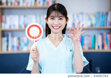 A nurse woman who puts out an OK plate 93085763