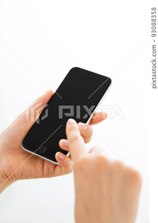 Young woman's hand holding a smartphone Young woman's hand holding a smartphone 93088358