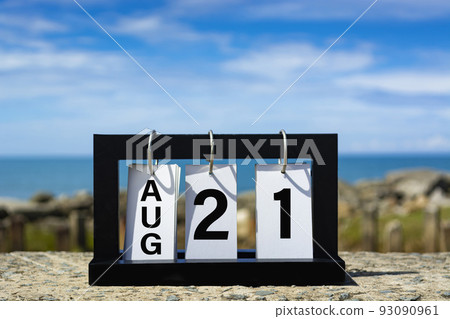 Aug 21 calendar date text on wooden frame with blurred background of ocean. Aug 21 calendar date text on wooden frame with blurred background of ocean. 93090961