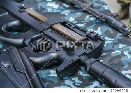 Automatic weapons on a table for a close-up demonstration Automatic weapons on a table for a close-up demonstration 93094368
