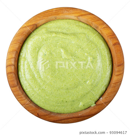 Green diet cream broccoli soup in a wooden plate isolated on white background. Vegan food. Green diet cream broccoli soup in a wooden plate isolated on white background. Vegan food. 93094617