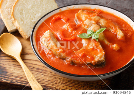 Thick hearty Soup with carp steak, vegetables and paprika close-up in a bowl. Horizontal Thick hearty Soup with carp steak, vegetables and paprika close-up in a bowl. Horizontal 93094846