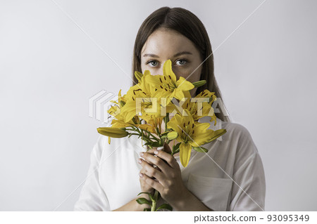 Beautiful young woman with fresh lilies on white background Beautiful young woman with fresh lilies on white background 93095349