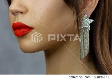 Close-up happy female smile with healthy white teeth, bright red gloss lips make-up. Cosmetology, dentistry and beauty care. Macro of woman's smiling mouth 93096147