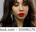 Close-up portrait of sexy european young woman model with classic glamour make-up and nude lipstick. Dark long hairstyle, christmas makeup, dark eyeshadows, natural pink lips with gloss 93096176