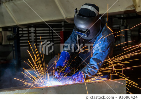 Worker welding steel in factory Worker welding steel in factory 93096424