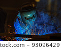 Worker is welding in factory 93096429