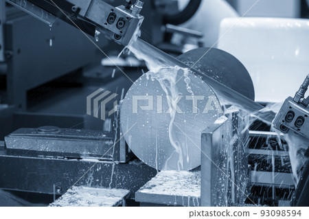 Close up scene the band saw machine cutting the metal rod with water base cooling method. Close up scene the band saw machine cutting the metal rod with water base cooling method. 93098594