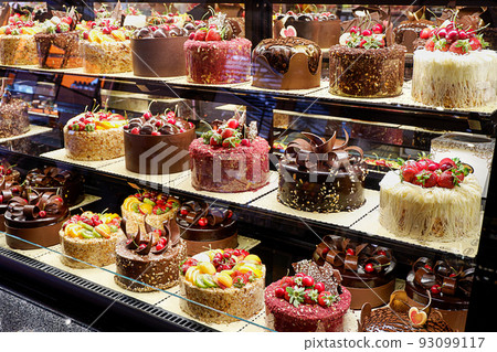 Assorted fancy cakes in a shop-window 93099117