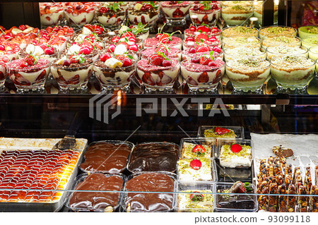 Assorted cakes in a shop-window Assorted cakes in a shop-window 93099118