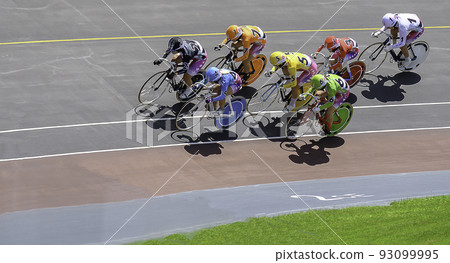 Bicycle racers running as a group on the bank of the velodrome 93099995