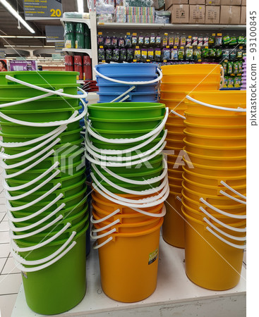 SELANGOR, MALAYSIA -JUNE 9, 2022: Several plastic buckets of various colors and sizes are displayed for sale in a supermarket. Separated according to design and size. Marked with a price tag. SELANGOR, MALAYSIA -JUNE 9, 2022: Several plastic buckets of various colors and sizes are displayed for sale in a supermarket. Separated according to design and size. Marked with a price tag. 93100845