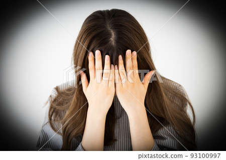 Sad young woman covering her face Sad young woman covering her face 93100997