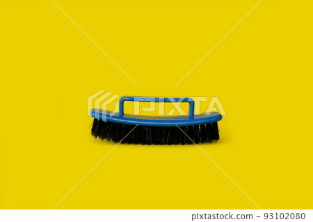 Brush for clothes on a bright yellow background 93102080