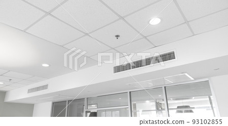 Ceiling mounted cassette type air conditioner and modern lamp light on white ceiling. duct air conditioner for home or office Ceiling mounted cassette type air conditioner and modern lamp light on white ceiling. duct air conditioner for home or office 93102855