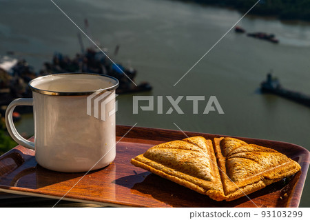 Breakfast - sandwiches and coffee on a wooden tray. Breakfast - sandwiches and coffee on a wooden tray. 93103299