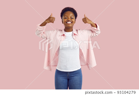 Joyful excited young African American woman showing thumbs up recommending advertising product. Joyful excited young African American woman showing thumbs up recommending advertising product. 93104279